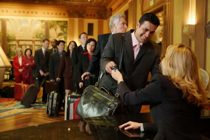 Businesspeople Checking into Hotel